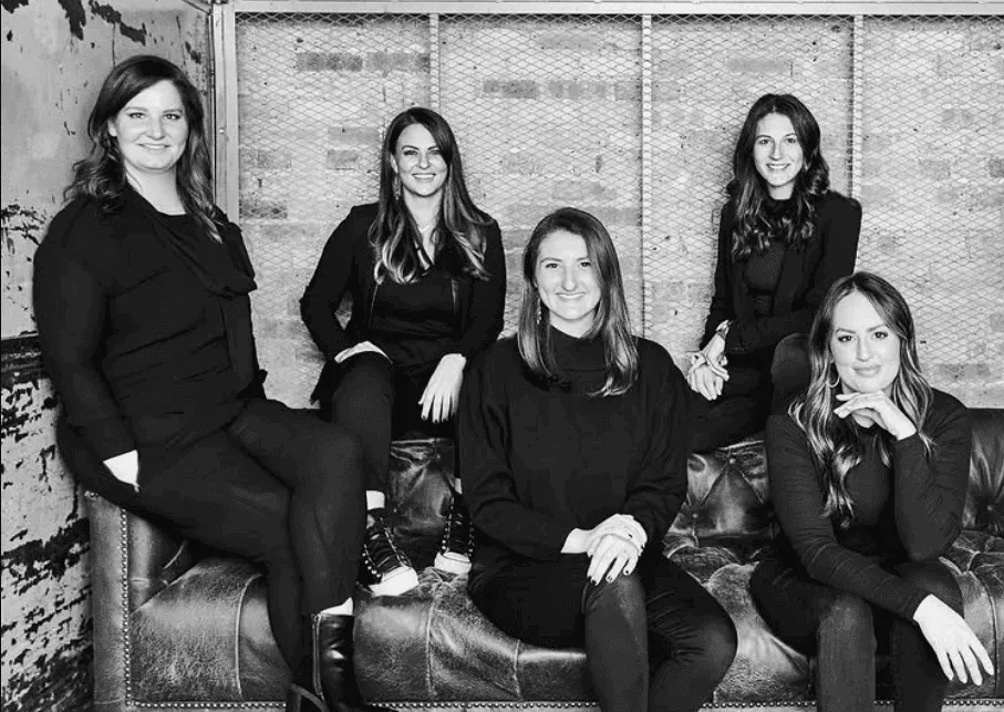 Five members of the Variant design team seated together for a black-and-white portrait.